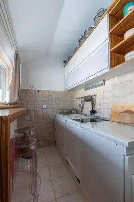 a kitchen with a sink and a counter top at Konaci Brvenik Suites in Kopaonik