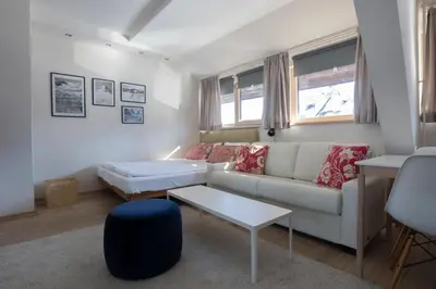 a living room with a couch and a table at Konaci Brvenik Suites in Kopaonik