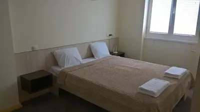 a bedroom with a bed with two towels on it at Apartments Mavesa in Vrnjačka Banja