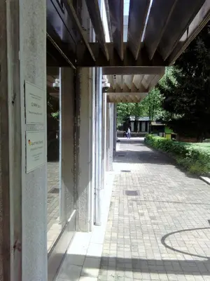 a building with awning over a walk way at Apartments Mavesa in Vrnjačka Banja