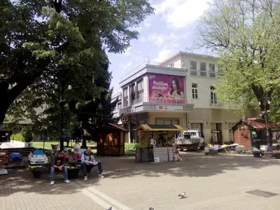 a group of people sitting in front of a building at Apartments Mavesa in Vrnjačka Banja