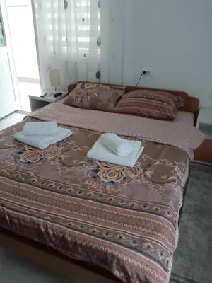 a bed with two towels on top of it at Seosko turisticko domacinstvo Milanovic in Žuč