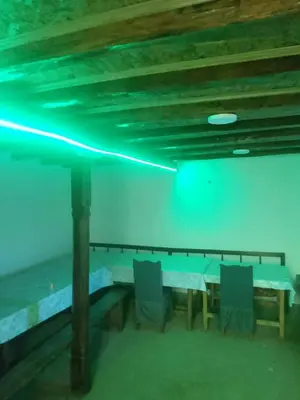 a room with a table and chairs and a beam of light at Seosko turisticko domacinstvo Milanovic in Žuč