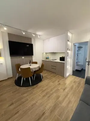 a kitchen and a dining room with a table and chairs at Mint2 in Kopaonik