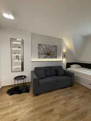 a living room with a couch and a bed at Mint2 in Kopaonik