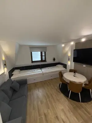 a living room with a large couch and a table at Mint2 in Kopaonik