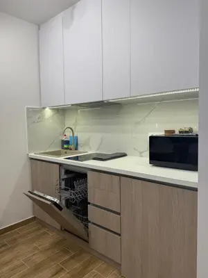 a kitchen with white cabinets and a microwave at Mint2 in Kopaonik