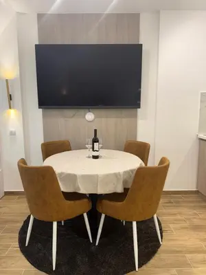 a table with chairs and a bottle of wine on it at Mint2 in Kopaonik