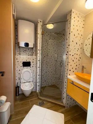 a bathroom with a shower with a toilet and a sink at Mint2 in Kopaonik