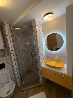 a bathroom with a shower and a toilet and a sink at Mint2 in Kopaonik