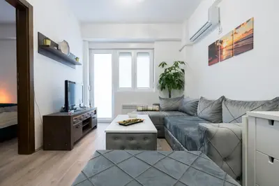 a living room with a couch and a tv at Apartman Vića in Jagodina