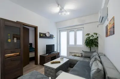 a living room with a couch and a tv at Apartman Vića in Jagodina