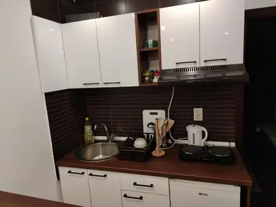 a kitchen with white cabinets and a sink at Drašković lux Goč in Goč