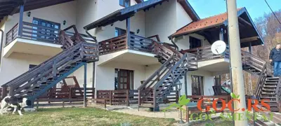a building with stairs and a dog standing in front of it at Drašković lux Goč in Goč