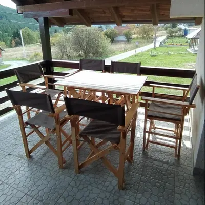a wooden table and chairs on a patio at Drašković lux Goč in Goč