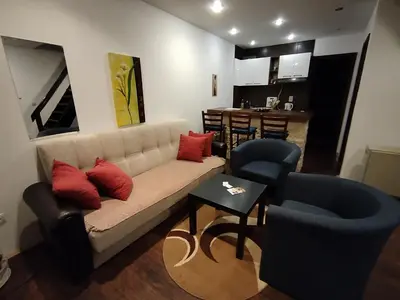 a living room with a couch and chairs and a kitchen at Drašković lux Goč in Goč
