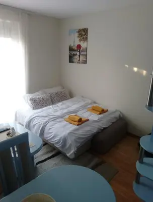 a bedroom with a bed with two towels on it at Apartman Fazan in Vrnjačka Banja