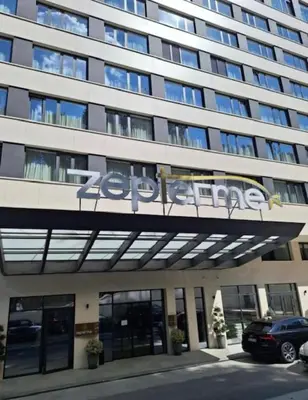a large building with a sign on the front of it at Zepterme lux in Vrnjačka Banja
