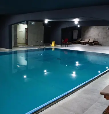 a large swimming pool in a building at Zepterme lux in Vrnjačka Banja