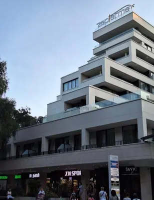 a building with people standing in front of it at Zepterme lux in Vrnjačka Banja