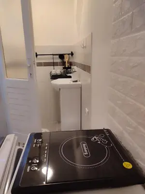 a record player sitting on top of a stove in a kitchen at Studio Sanja in Niš