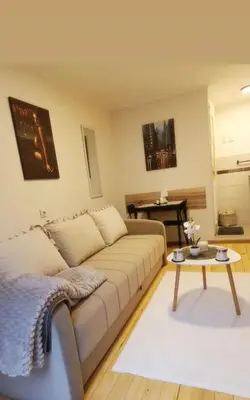 a living room with a couch and a table at Studio Sanja in Niš