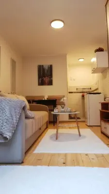 a living room with a couch and a table at Studio Sanja in Niš