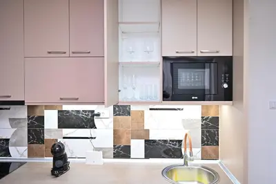 a kitchen with a sink and a microwave at Studio Idila in Raška