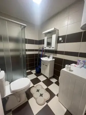 a bathroom with a shower and a toilet and a sink at Apartman Sinđelić lux in Pirot