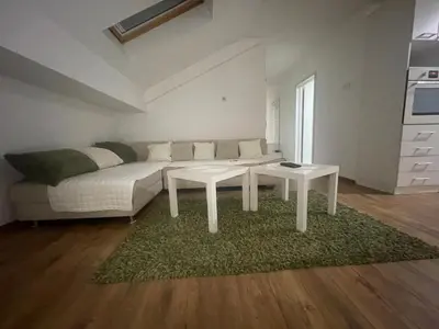 a living room with a couch and a table at Apartman Sinđelić lux in Pirot