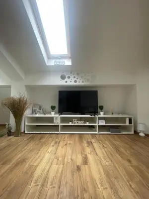 a large living room with a flat screen tv at Apartman Sinđelić lux in Pirot