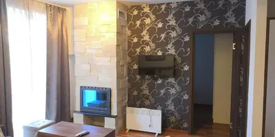 a living room with a tv on a wall at Kraljevi Cardaci SPA Aartment 1027 für 6 Personen in Kopaonik