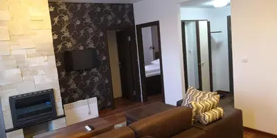 a living room with a couch and a television at Kraljevi Cardaci SPA Aartment 1027 für 6 Personen in Kopaonik