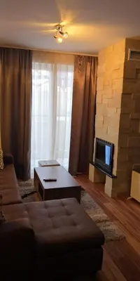 a living room with a couch and a tv at Kraljevi Cardaci SPA Aartment 1027 für 6 Personen in Kopaonik