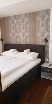 a bedroom with a large bed with white pillows at Kraljevi Cardaci SPA Aartment 1027 für 6 Personen in Kopaonik