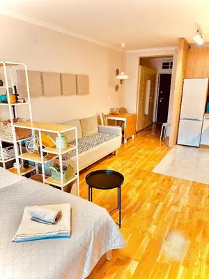 a room with two beds and a living room at Studio 4 in Pirot