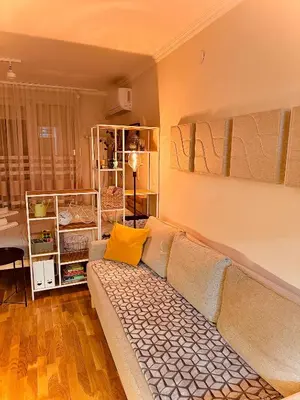 a living room with a couch with a yellow pillow at Studio 4 in Pirot