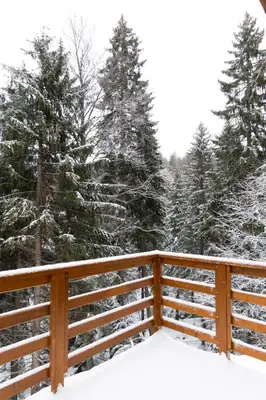 a wooden fence in the snow with trees at Gorska Vila in Kopaonik