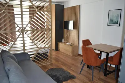 a living room with a couch and a table at A 14 President Kopaonik in Raška