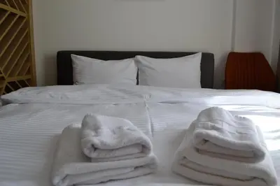 a bed with white towels on top of it at A 14 President Kopaonik in Raška