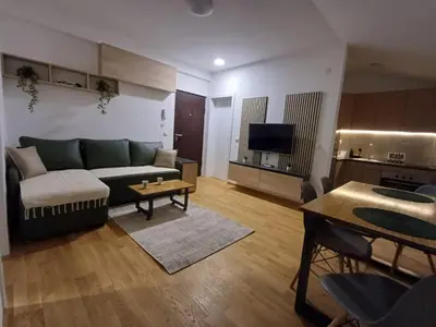 a living room with a couch and a table at Forest River Sokobanja in Soko Banja