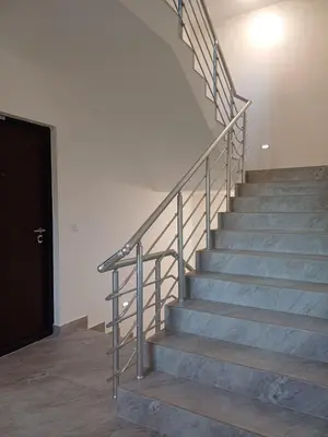 a set of stairs in a building with a black door at Forest River Sokobanja in Soko Banja