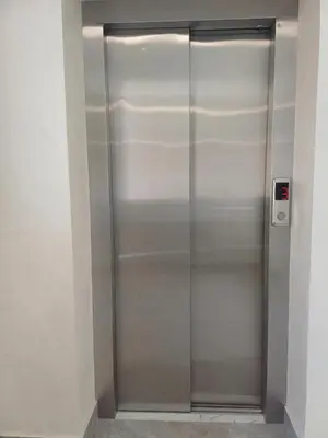a stainless steel elevator in a building at Forest River Sokobanja in Soko Banja