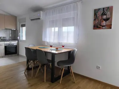 a kitchen with a table with two glasses of wine at Forest River Sokobanja in Soko Banja