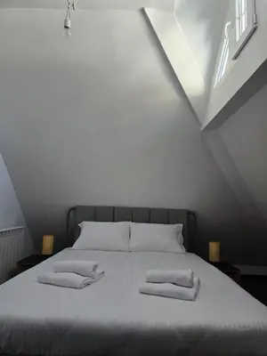 a bedroom with a bed with two pillows on it at Weg City Apartmani in Brzeće