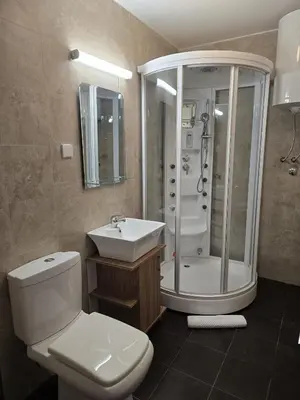 a bathroom with a toilet and a shower and a sink at Weg City Apartmani in Brzeće
