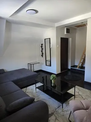 a living room with a couch and a table at Weg City Apartmani in Brzeće