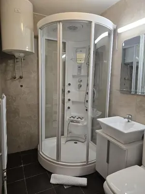 a bathroom with a shower and a sink at Weg City Apartmani in Brzeće