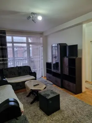 a living room with a couch and a tv at Vucko Apartmani in Prokuplje