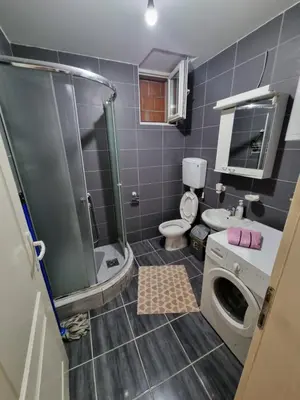 a bathroom with a shower and a toilet and a sink at Vucko Apartmani in Prokuplje